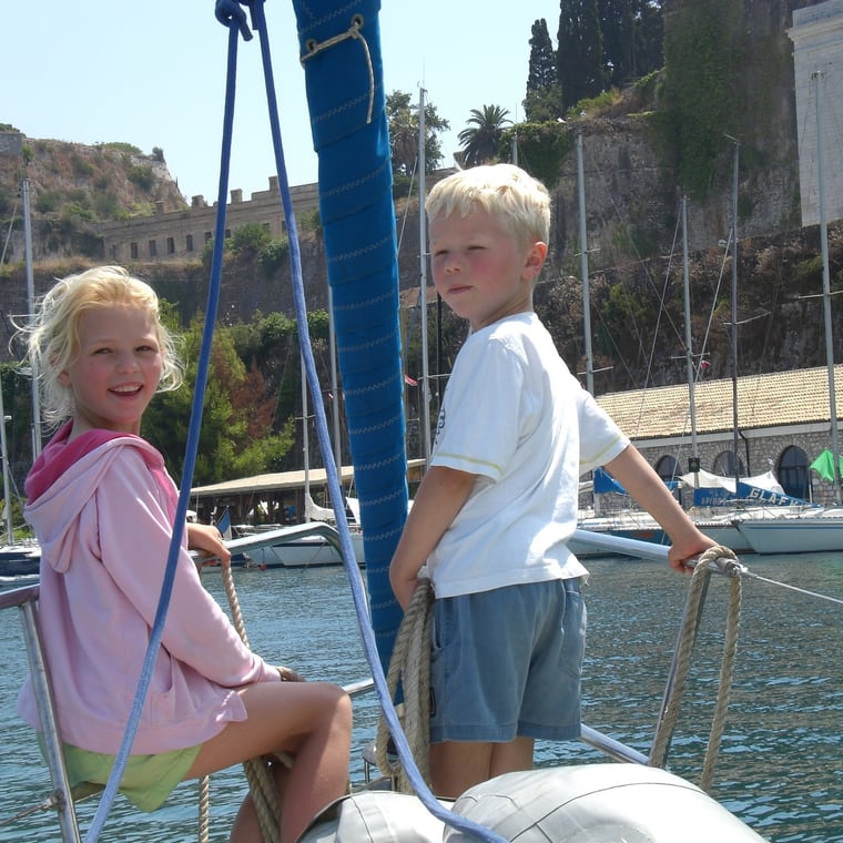 Mark and Sacha as children on a sailboat in Corfu.